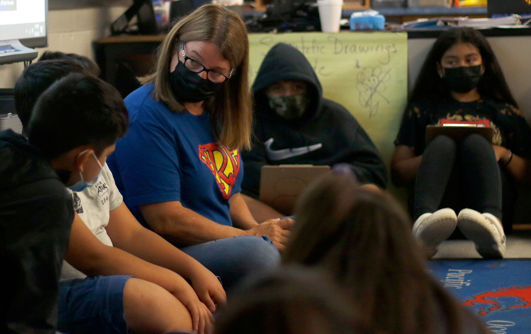 Fifth grade teacher Kelly Pulliam listens to one of her students
